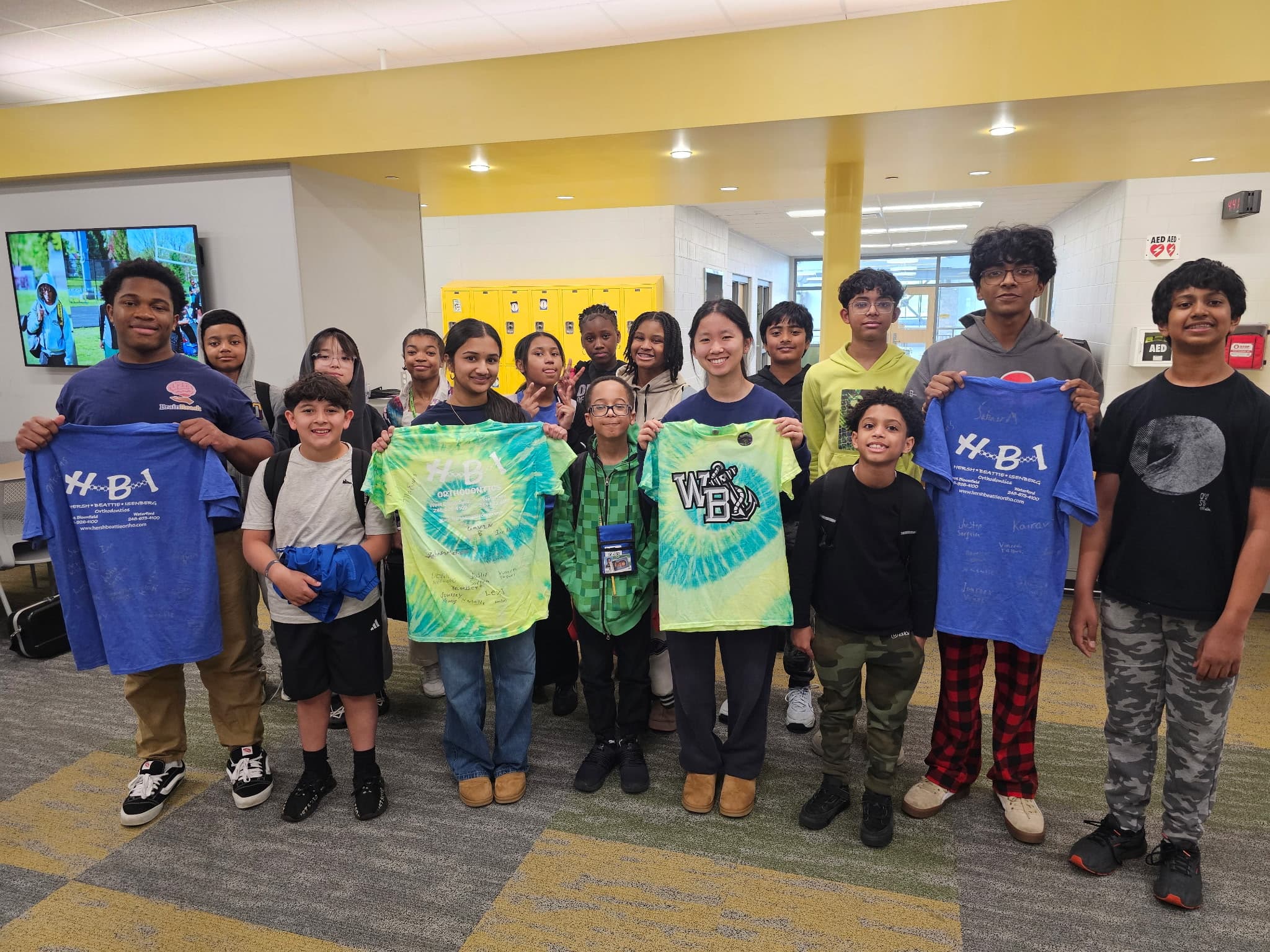 BrainReach students group photo holding workshop shirts
